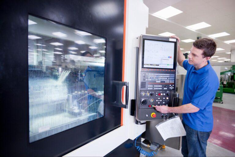 technik ustawiający parametry pracy maszyny produkcyjnej